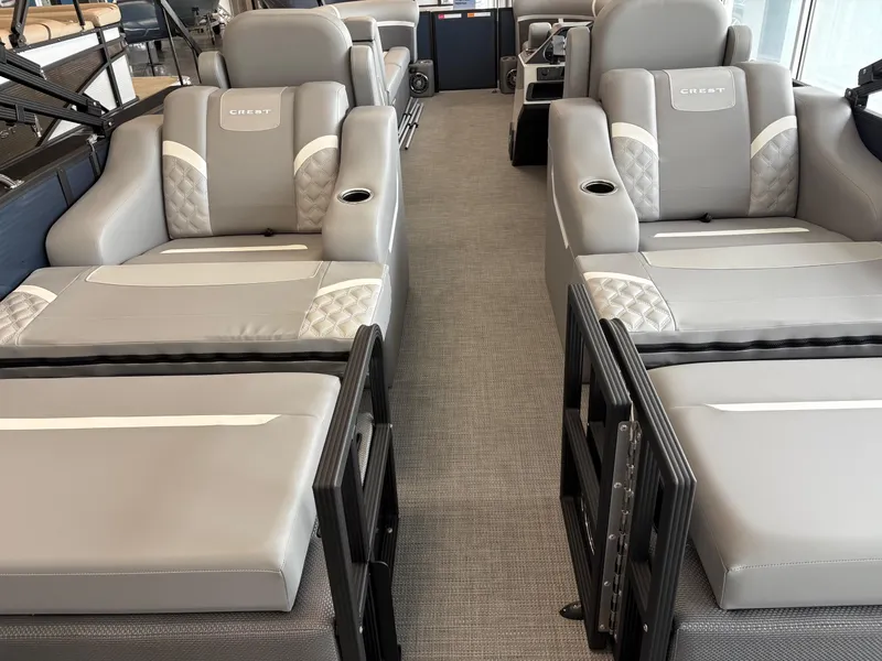 Slide: The Image of Luxurious seating on 2025 Crest 240 SLRC boat, featuring plush gray upholstery and cup holders. - 3