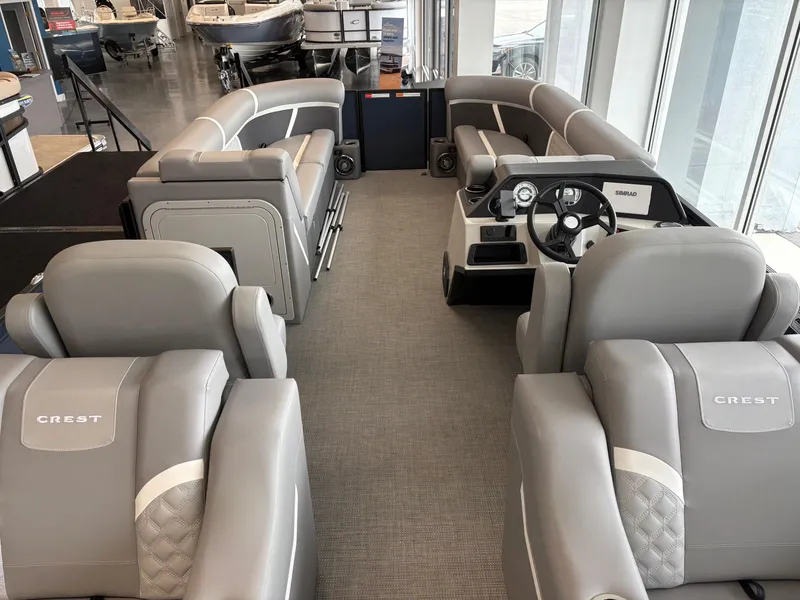 Slide: The Image of 2025 Crest 240 SLRC pontoon boat interior with luxurious gray seating and modern dashboard. - 5