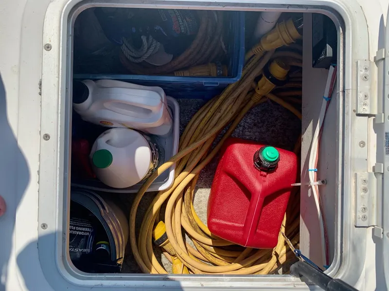 Slide: The Image of Open hatch on PDQ-34 boat showing ropes and cables inside. - 13