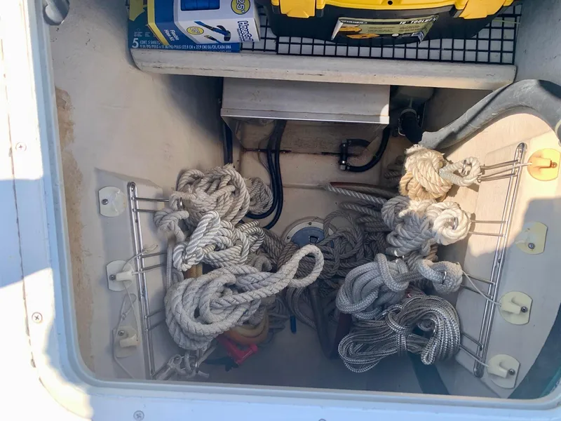 Slide: The Image of Toolbox and hose kit in PDQ-34 boat storage, featuring ropes and electrical components. - 15