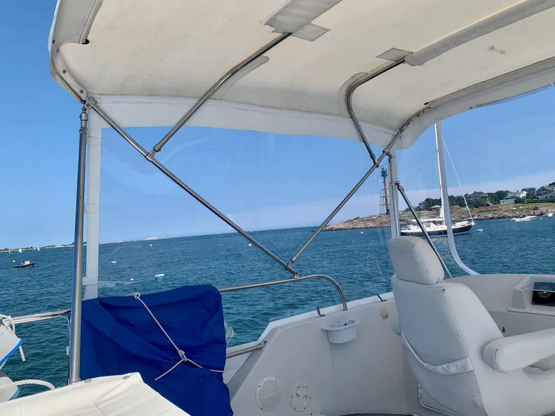 Slide: The Image of View from a 2003 PDQ-34 boat overlooking a scenic harbor with moored boats. - 18