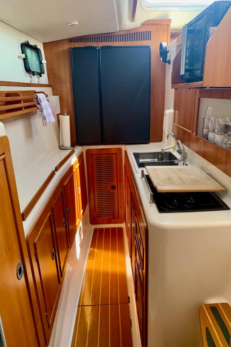 Slide: The Image of Cozy cabin interior of 2003 PDQ-34 boat with bed and wooden cabinetry. - 22