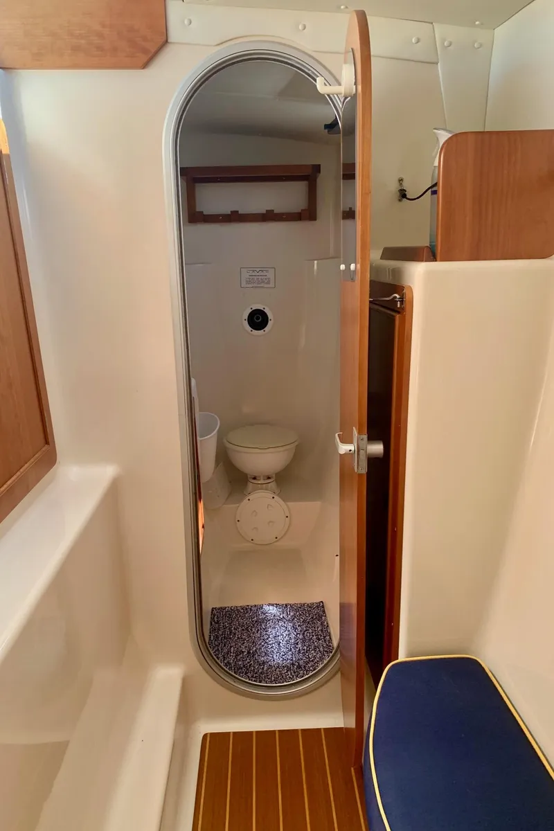 Slide: The Image of Compact marine bathroom in 2003 PDQ-34 boat with toilet, sink, and storage. - 25