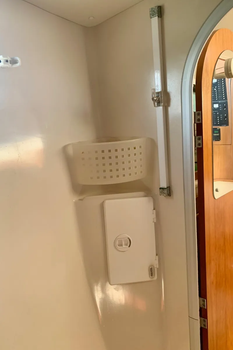 Slide: The Image of Electrical panel on a 2003 PDQ-34 boat, featuring 12V DC and 120V AC systems. - 27