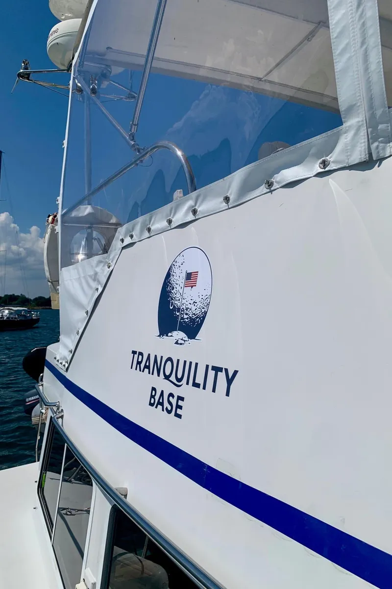 Slide: The Image of Engine compartment of a 2003 PDQ-34 boat, showing hoses and mechanical components. - 33