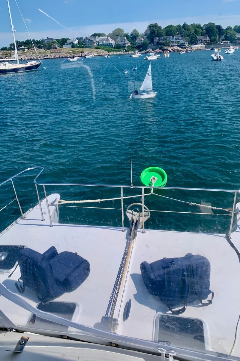 Slide: The Image of Engine compartment of a 2003 PDQ-34 boat, showcasing mechanical components and hoses. - 35