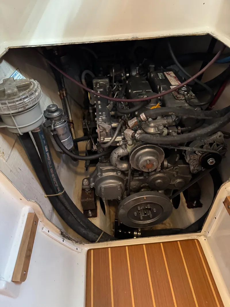Slide: The Image of Engine compartment of a 2003 PDQ-34 boat, showcasing mechanical components and hoses. - 37