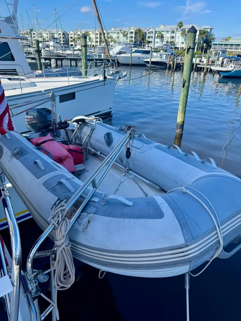 Slide: The Image of Inflatable dinghy docked at marina, near PDQ-34 boat, 2003 model. - 4