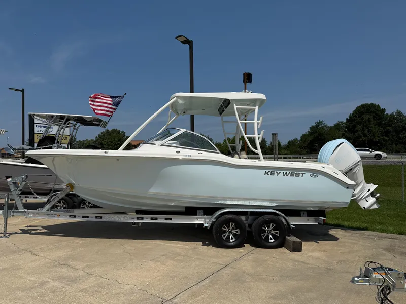 The Image of 2026 Key West 239 DFS boat on trailer, American flag in background. - 0