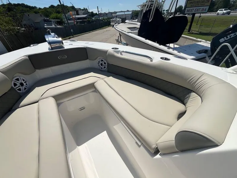 Slide: The Image of 2026 Key West 239 DFS boat interior with beige seating and speakers. - 13