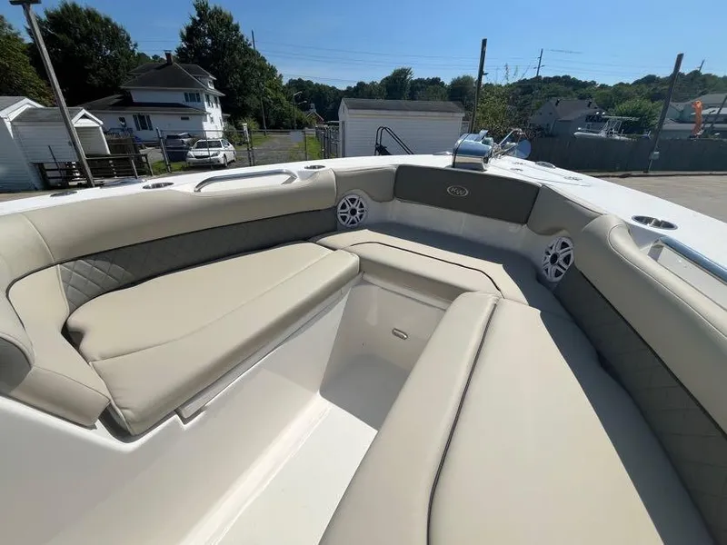 Slide: The Image of 2026 Key West 239 DFS boat interior with beige seating and speakers. - 14