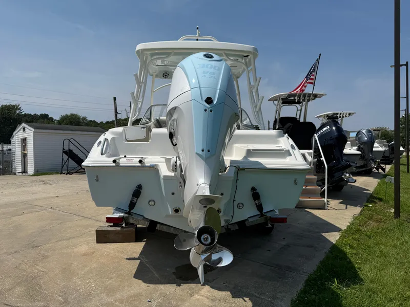 Slide: The Image of 2026 Key West 239 DFS boat with outboard motor, displayed outdoors. - 2