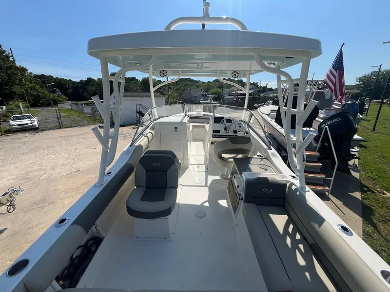 Slide: The Image of 2026 Key West 239 DFS boat interior with seating, steering wheel, and American flag in the background. - 3