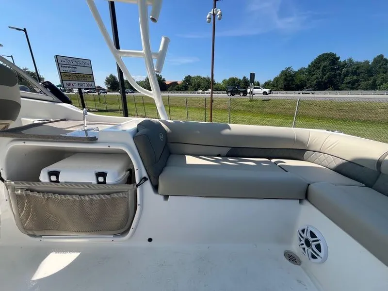 Slide: The Image of Interior of 2026 Key West 239 DFS boat with seating and storage, parked near a highway. - 5