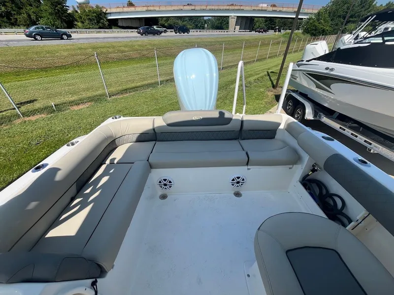 Slide: The Image of 2026 Key West 239 DFS boat interior with seating, parked near highway. - 6