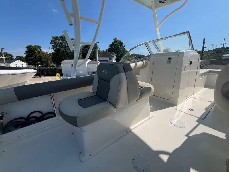 Slide: The Image of 2026 Key West 239 DFS boat interior with seating and console, under clear blue sky. - 8
