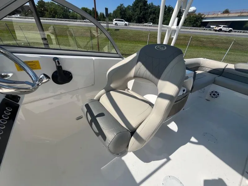 Slide: The Image of 2026 Key West 239 DFS boat interior with steering wheel and comfortable seating. - 9