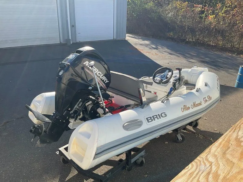 Slide: The Image of 2016 Brig F330HT inflatable boat with Mercury outboard motor on a trailer. - 3