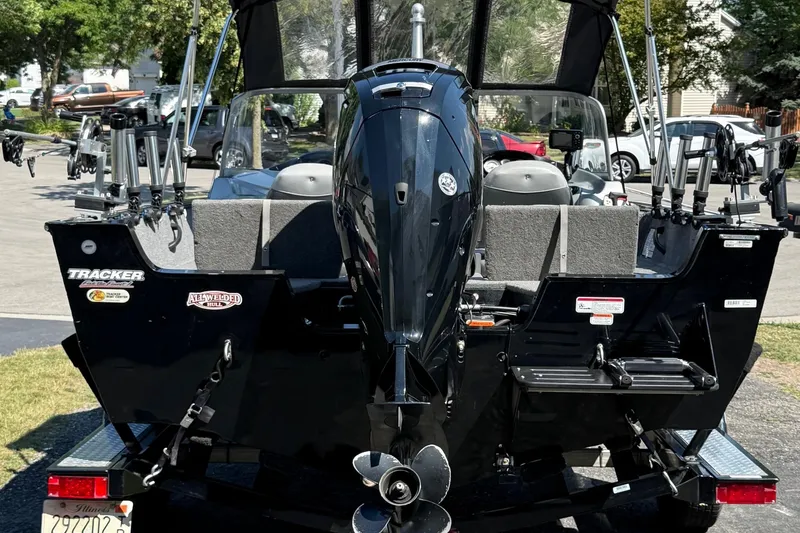 Slide: The Image of 2015 Tracker Pro Guide V-175 WT boat with motor, parked on trailer, rear view. - 10