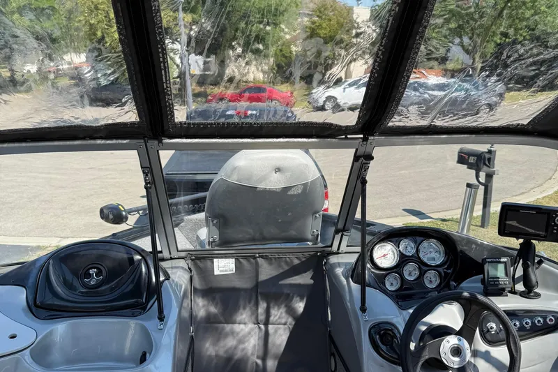 Slide: The Image of Interior view of a 2015 Tracker Pro Guide V-175 WT boat, showcasing dashboard and controls. - 13