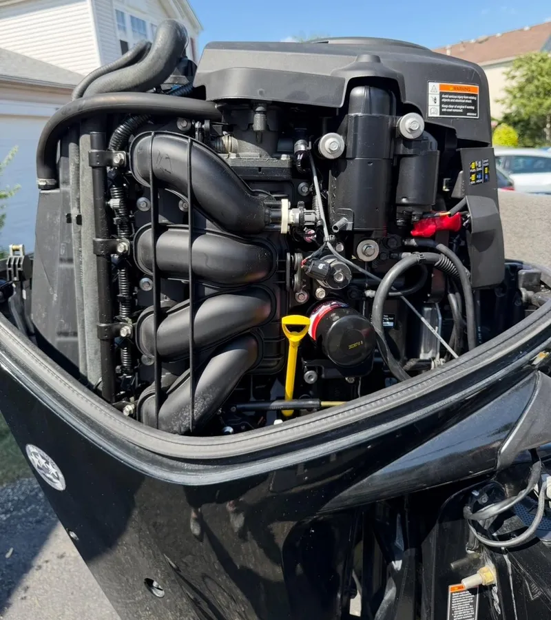 Slide: The Image of 2015 Tracker Pro Guide V-175 WT boat engine close-up, showcasing intricate mechanical components. - 18