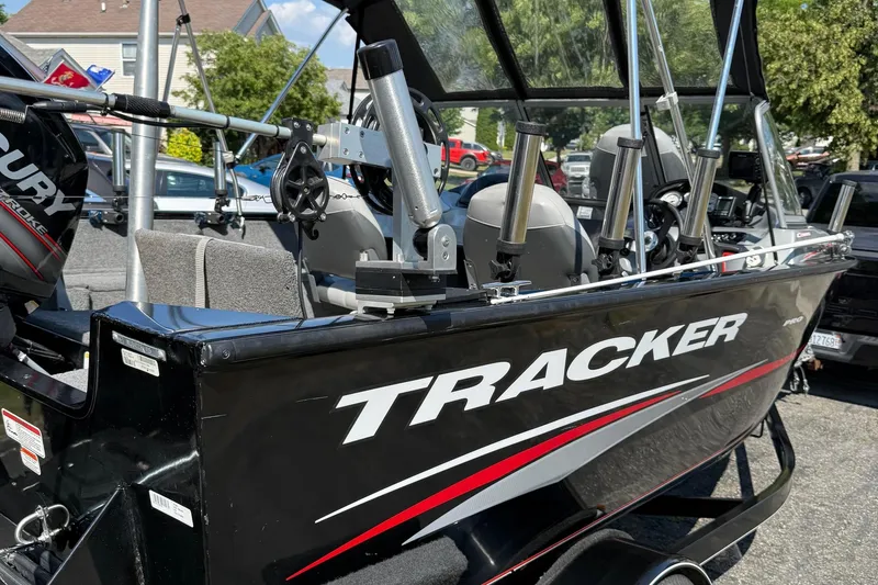 Slide: The Image of 2015 Tracker Pro Guide V-175 WT boat with Mercury engine, parked outdoors. - 4