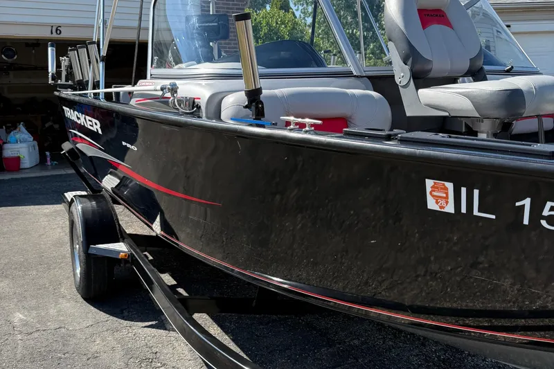 Slide: The Image of 2015 Tracker Pro Guide V-175 WT boat on trailer, parked in driveway. - 6