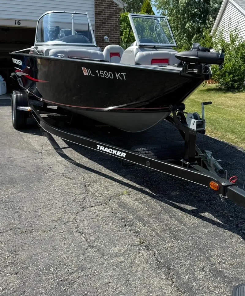 Slide: The Image of 2015 Tracker Pro Guide V-175 WT boat on trailer in driveway. - 7