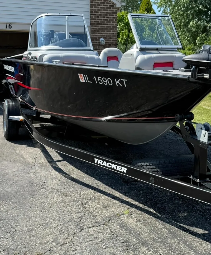 Slide: The Image of 2015 Tracker Pro Guide V-175 WT boat on trailer, parked in driveway. - 8