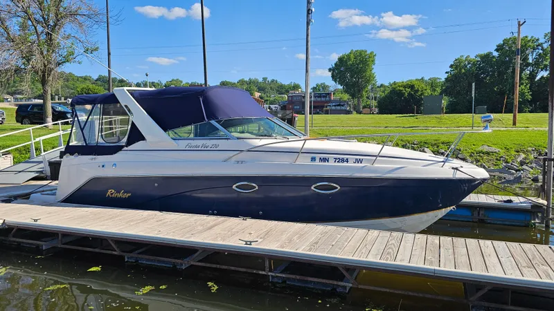 Slide: The Image of 2003 Rinker Fiesta Vee 270 boat docked on a sunny day. - 1