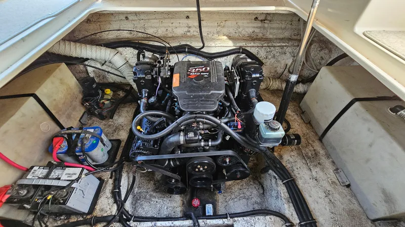 Slide: The Image of Engine compartment of a 2003 Rinker Fiesta Vee 270 boat, featuring a 250 MAG MPI engine. - 21