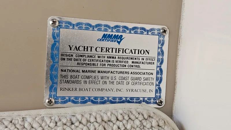 Slide: The Image of Yacht certification plaque on 2003 Rinker Fiesta Vee 270, NMMA compliance details. - 23