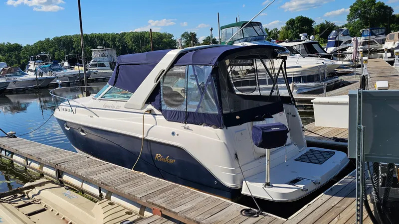 Slide: The Image of 2003 Rinker Fiesta Vee 270 boat docked at marina under clear blue sky. - 3