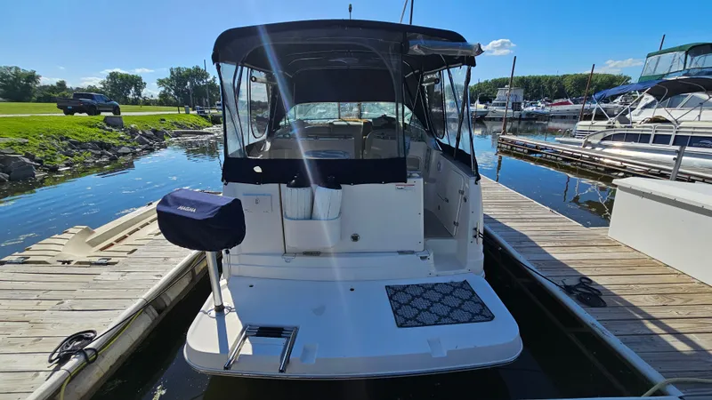 Slide: The Image of 2003 Rinker Fiesta Vee 270 docked at marina, sunny day, calm water. - 4