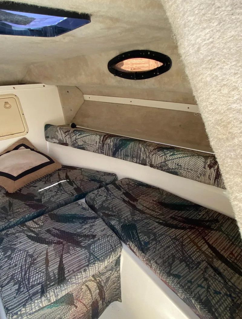 Slide: The Image of Cabin interior of 1999 Key West 2020WA Bluewater boat with patterned seating and porthole window. - 10