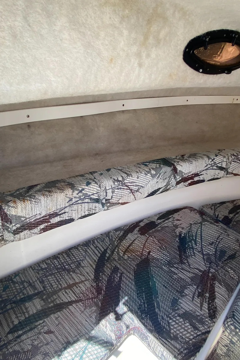 Slide: The Image of Interior cabin of 1999 Key West 2020WA Bluewater boat with patterned upholstery. - 11