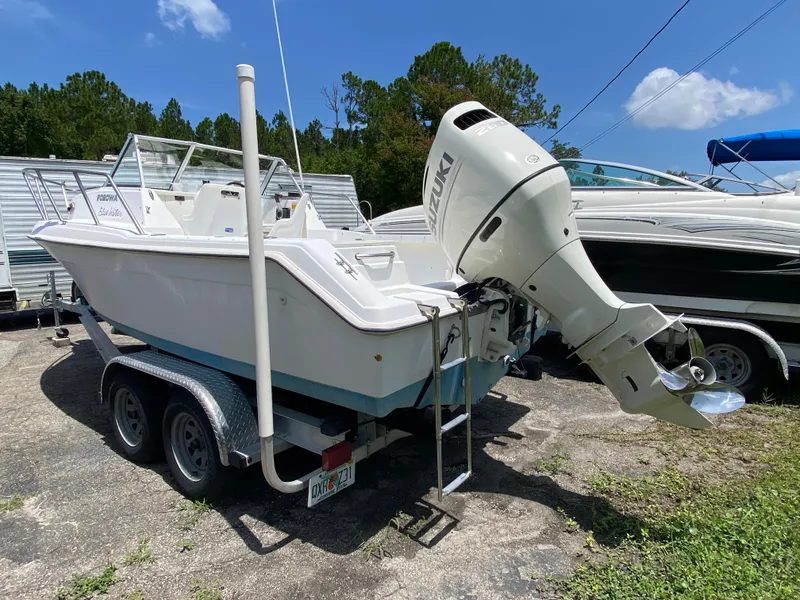 Slide: The Image of 1999 Key West 2020WA Bluewater boat on trailer with Suzuki outboard motor. - 3