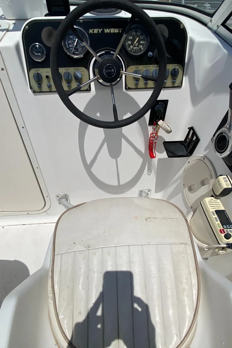Slide: The Image of Steering console of 1999 Key West 2020WA Bluewater boat with gauges and controls. - 8