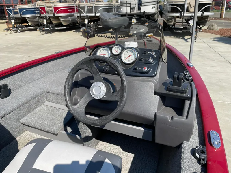 Slide: The Image of 2022 Tracker Super Guide V-16 SC boat dashboard with steering wheel and gauges. - 2
