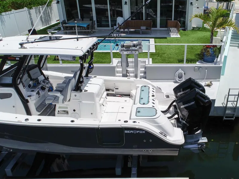 Slide: The Image of 2024 Sea Fox 328 Commander boat docked, featuring dual Mercury engines and modern cockpit design. - 10