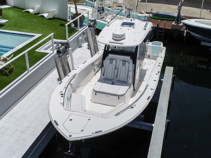 Slide: The Image of 2024 Sea Fox 328 Commander boat docked, showcasing sleek design and spacious deck. - 4