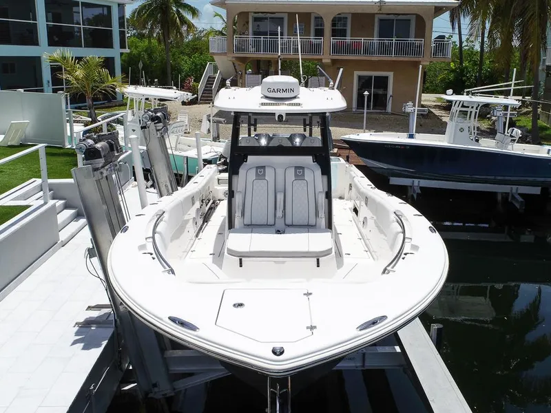Slide: The Image of 2024 Sea Fox 328 Commander boat docked, featuring a sleek design and advanced Garmin navigation system. - 6