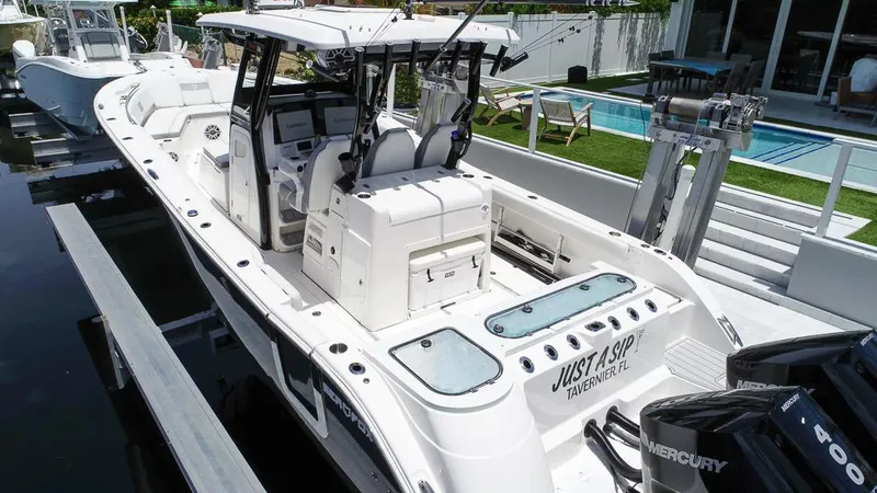 Slide: The Image of 2024 Sea Fox 328 Commander boat docked, featuring dual Mercury engines and spacious seating. - 9