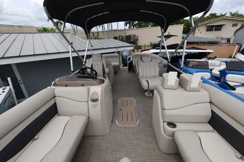Slide: The Image of 2019 Bennington SX 22 SSXP pontoon boat interior with beige seating and canopy. - 10