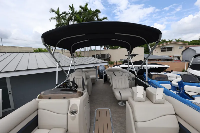 Slide: The Image of 2019 Bennington SX 22 SSXP pontoon boat with canopy and seating, docked outdoors. - 11
