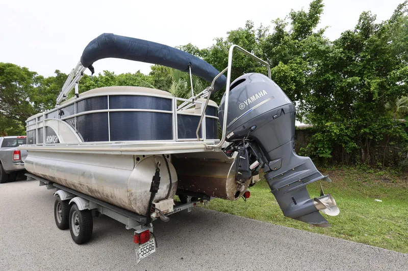 Slide: The Image of 2019 Bennington SX 22 SSXP pontoon boat with Yamaha outboard motor on trailer. - 2