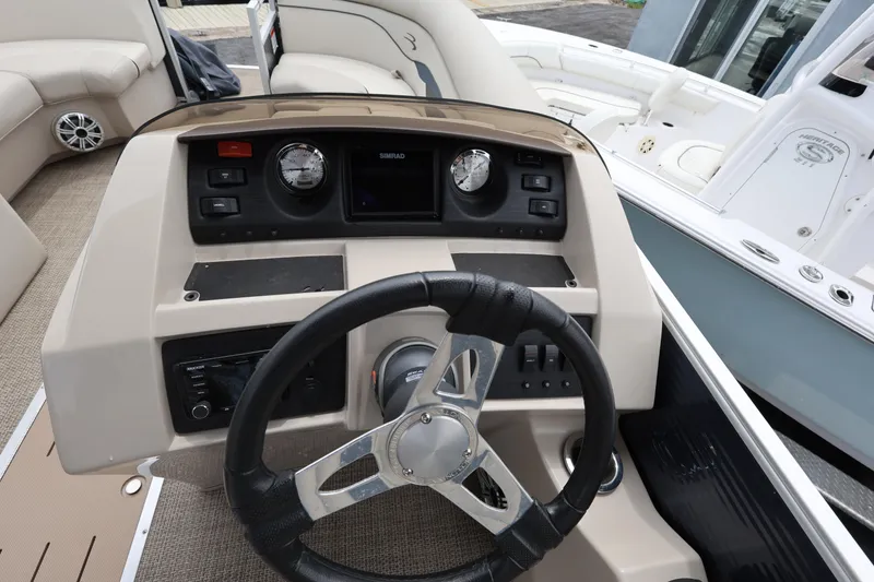 Slide: The Image of 2019 Bennington SX 22 SSXP boat dashboard with steering wheel and control panel. - 20