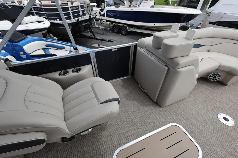 Slide: The Image of 2019 Bennington SX 22 SSXP pontoon boat interior with beige seating and cup holders. - 22