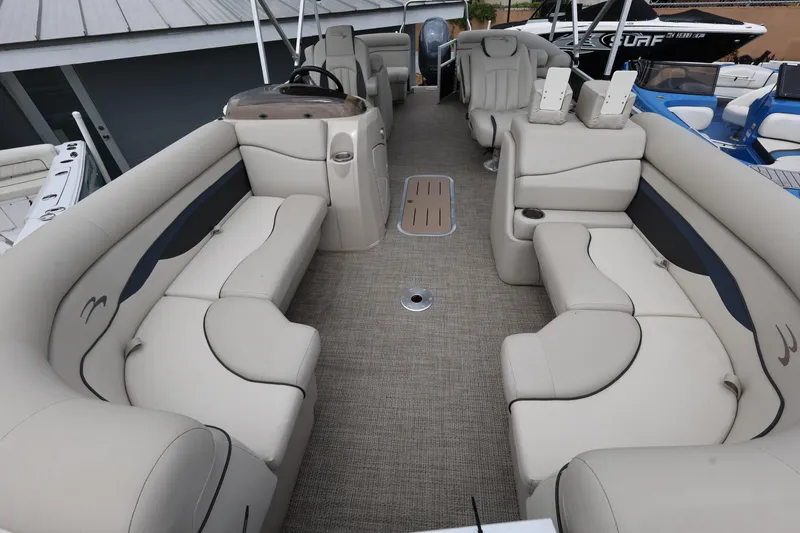 Slide: The Image of 2019 Bennington SX 22 SSXP pontoon boat interior with beige seating and steering console. - 9