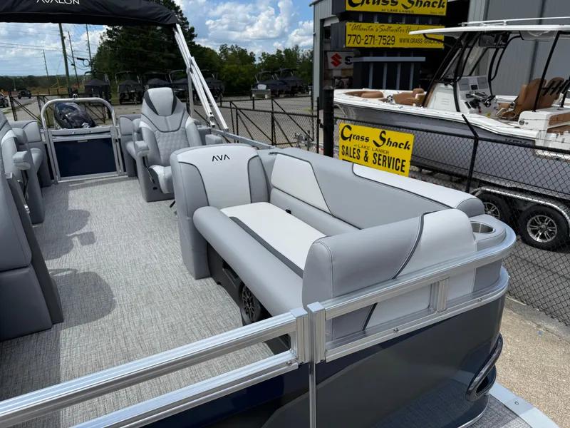 Slide: The Image of 2025 Avalon VENTURE QUAD LOUNGER pontoon boat with luxurious seating at a sales lot. - 12